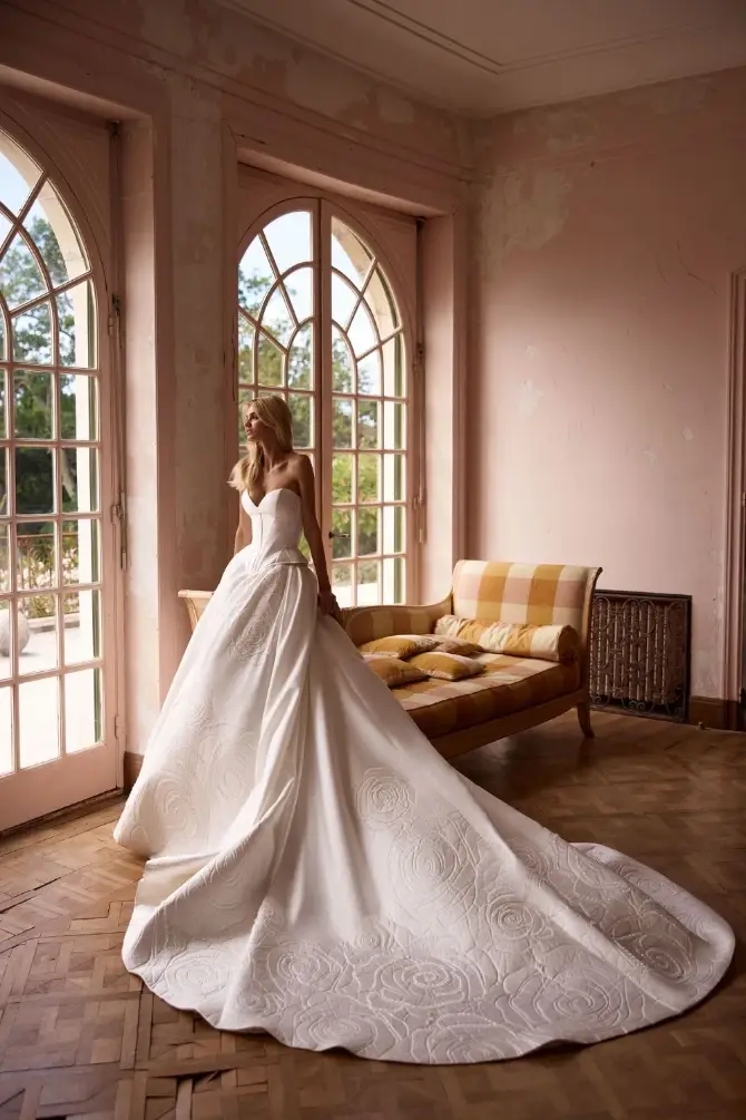 model is wearing a bold ball gown by milla nova 