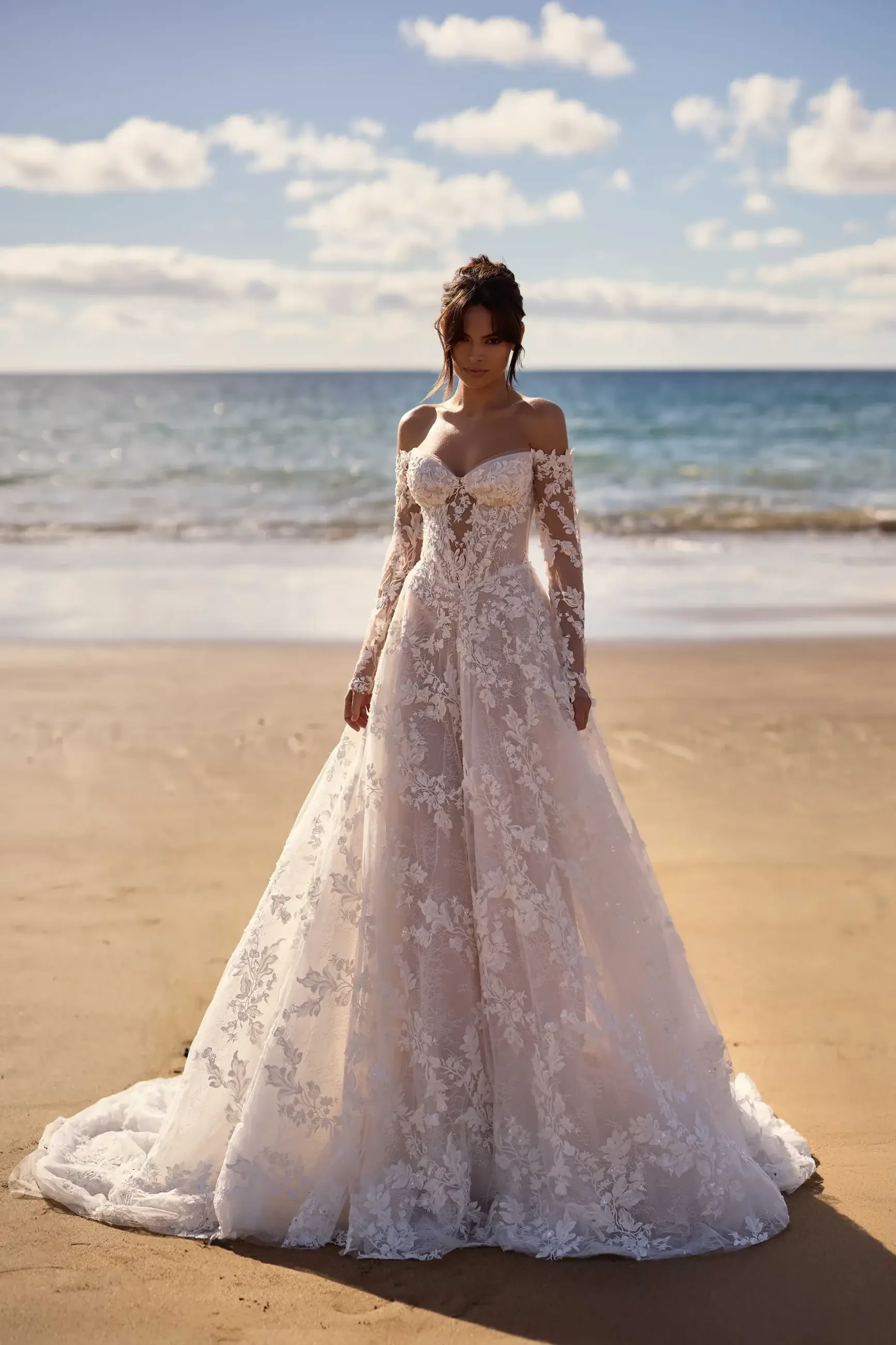 model is wearing an off the shoulder a-line wedding dress by milla nova